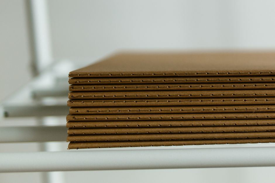 A stack of flat corrugated sheets